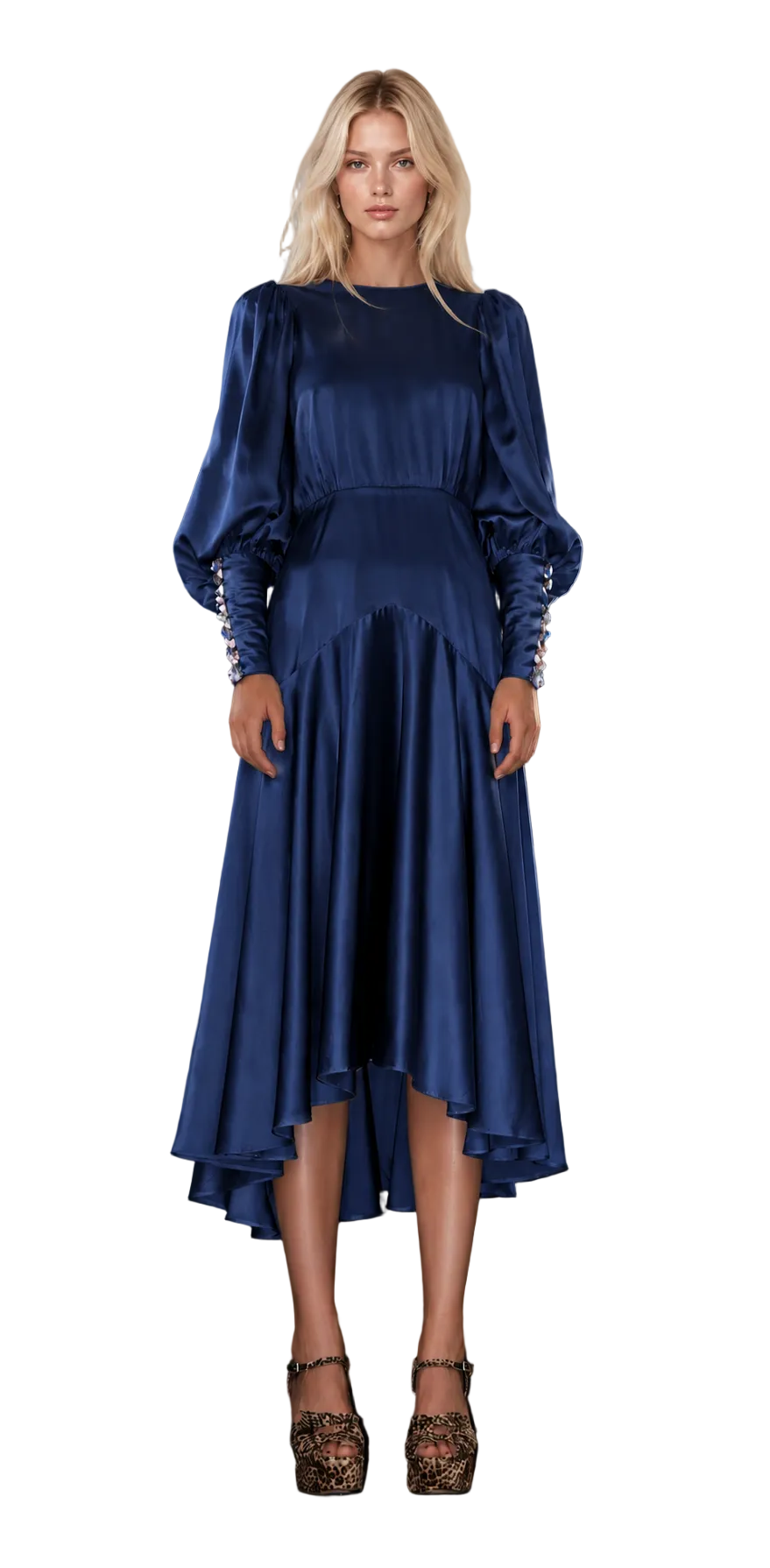 A woman stands on stone stairs wearing a long-sleeved navy blue satin midi dress with a high-low hem and leopard-print heels.