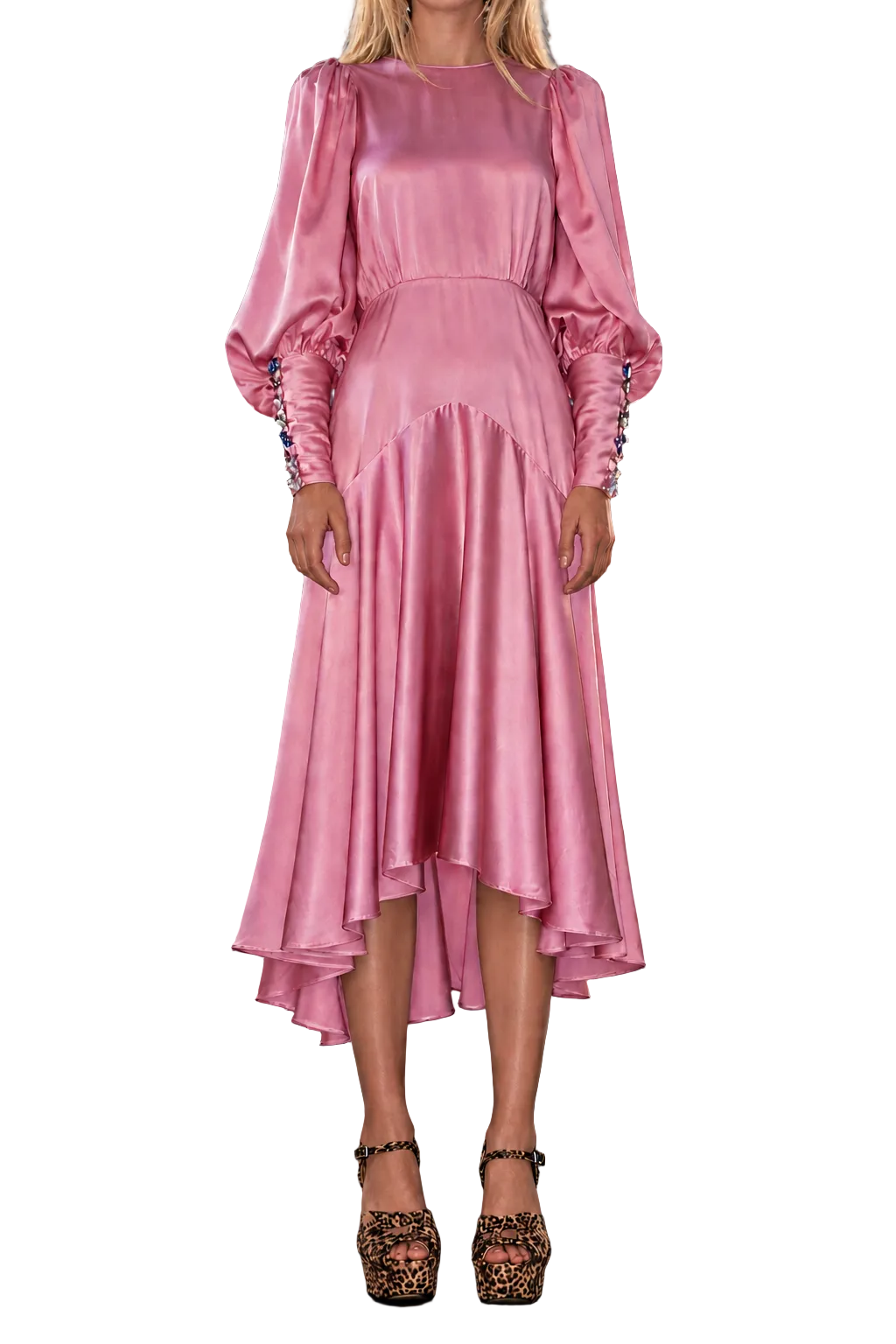 A model wearing a pink satin midi dress with puffed long sleeves and a tiered skirt, paired with leopard-print high heels, set against a dark stormy sky background.