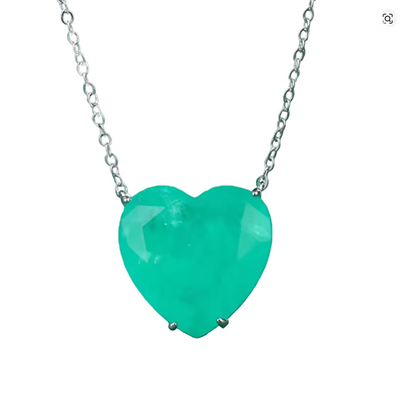 A heart-shaped green gemstone pendant necklace on a silver chain, set against a dark green textured background.