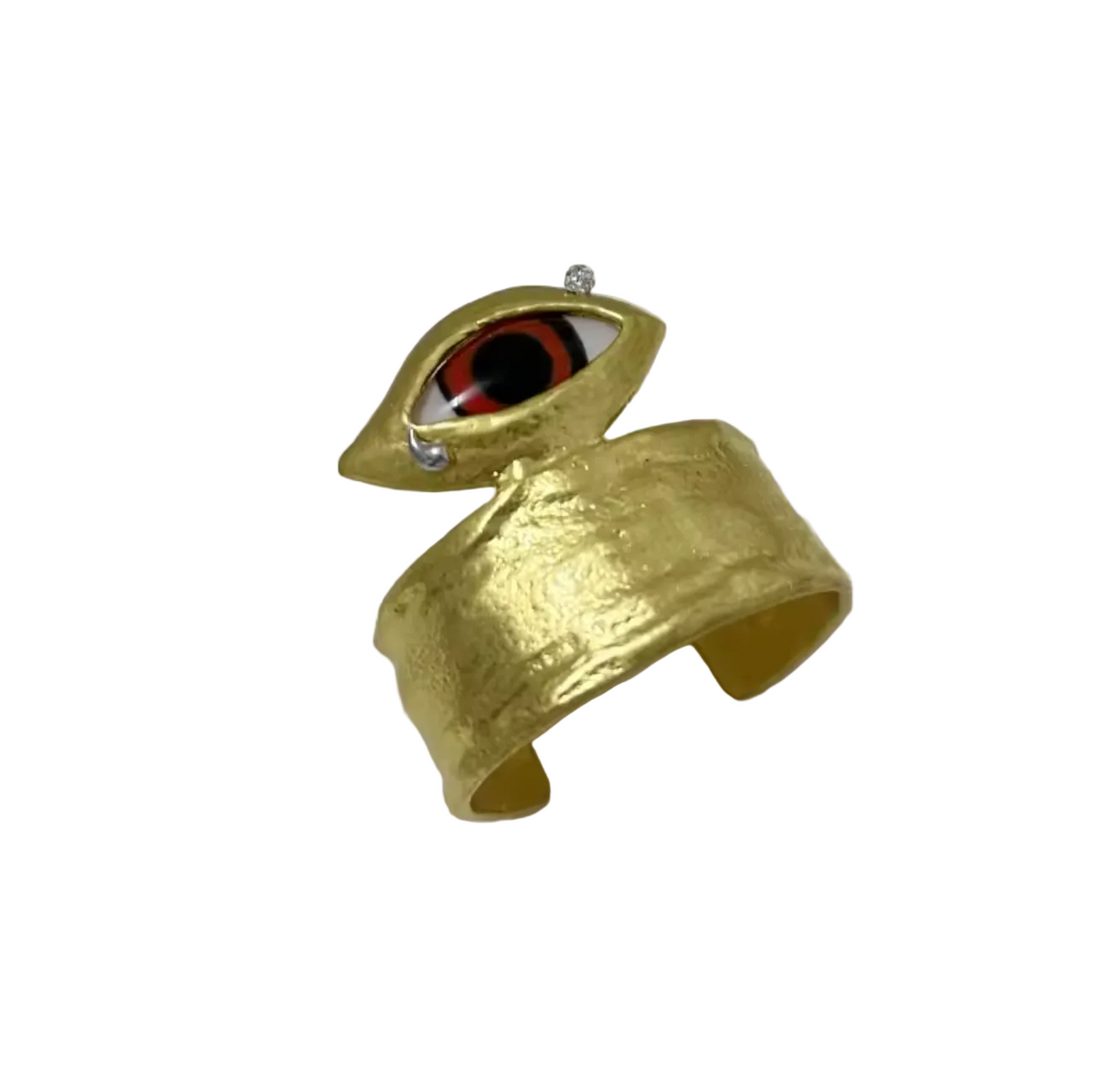 Gold cuff bracelet with eye design on a white surface