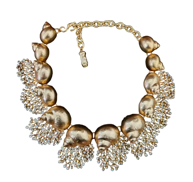 A gold statement necklace featuring textured shell-shaped beads and cascading crystal clusters, high end structural
