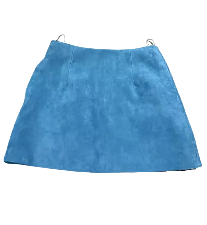 A bright blue suede mini skirt laid flat on top of leopard print and brown textured fabric pieces.